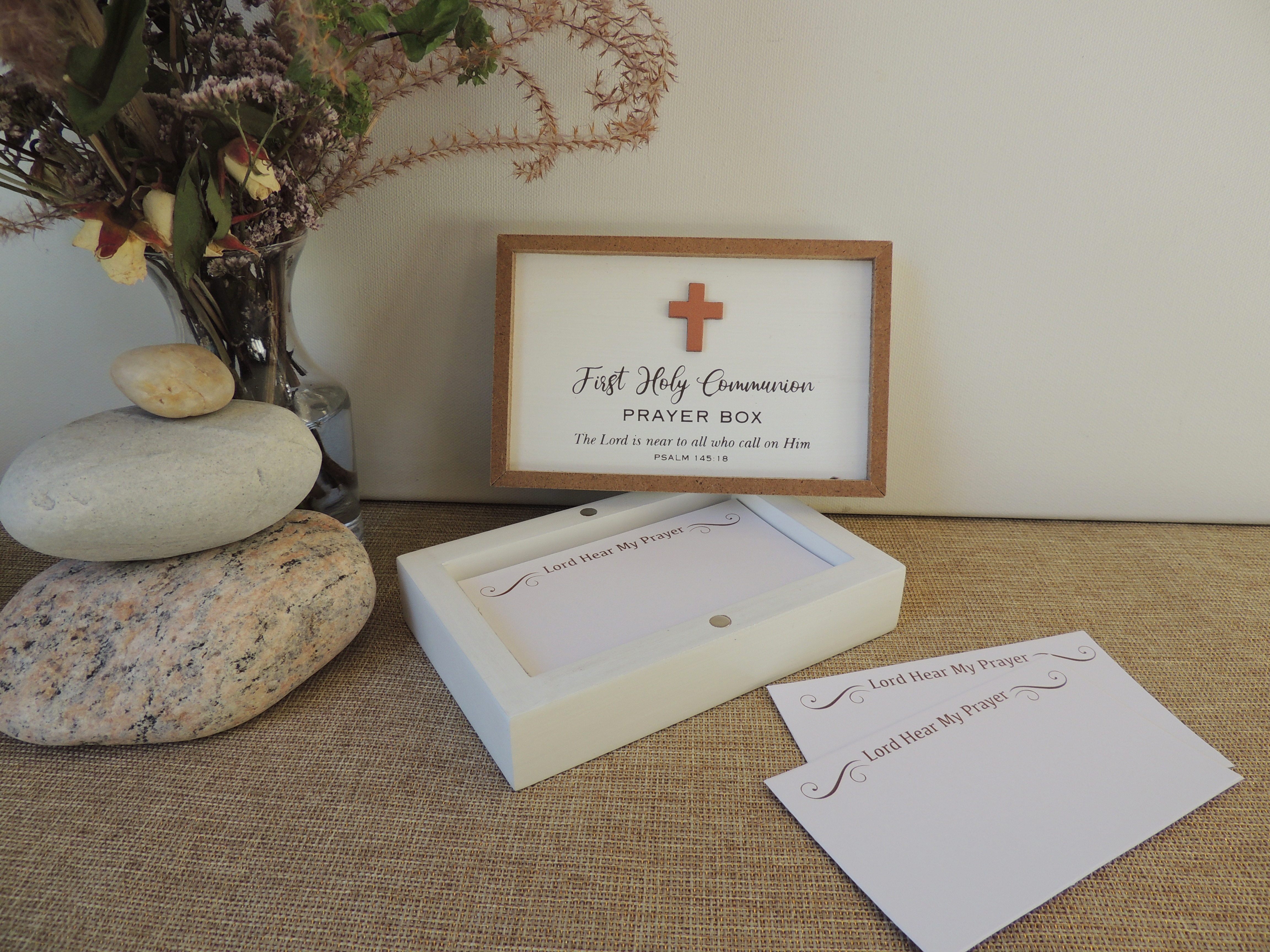 First Communion Prayer Box. Whitewashed and natural framed wood with 3D cross embellishment with magnetic closure lid. 25 prayer cards. 5.5in X3.5in X 2in D