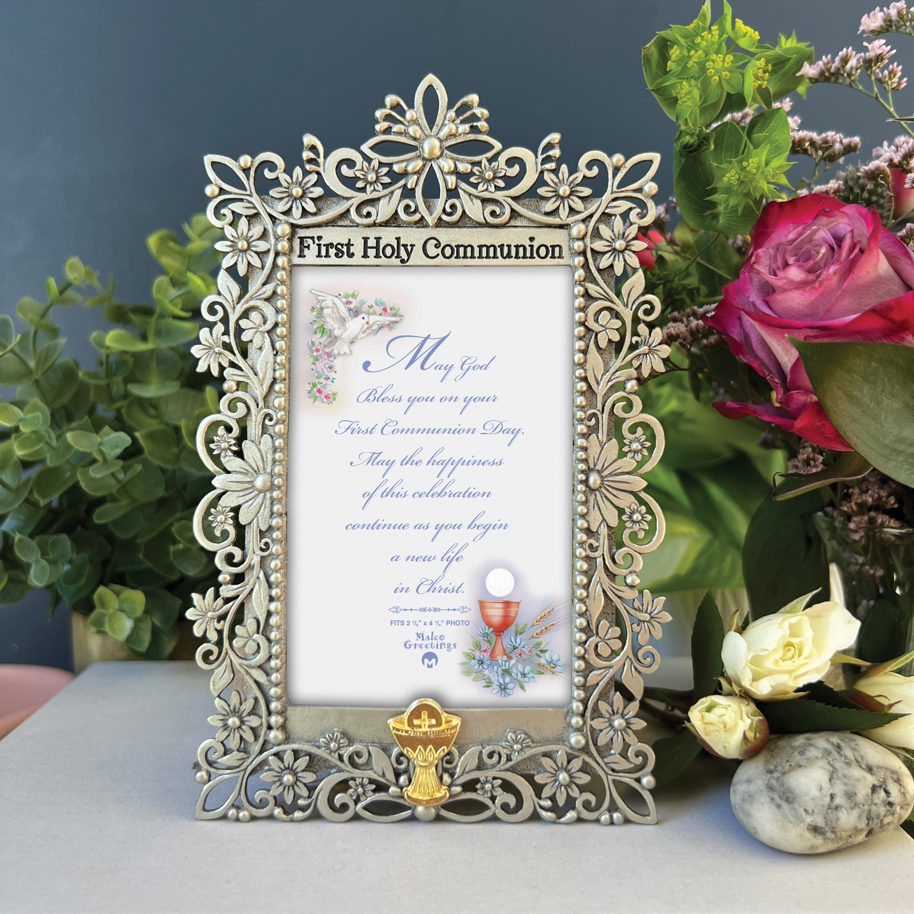 First Communion cast metal filigree frame finished in silver enamel with bright gold chalice embellishment. Holds 2.5in x 4.25in photo. Frame is 4in x 6.25in