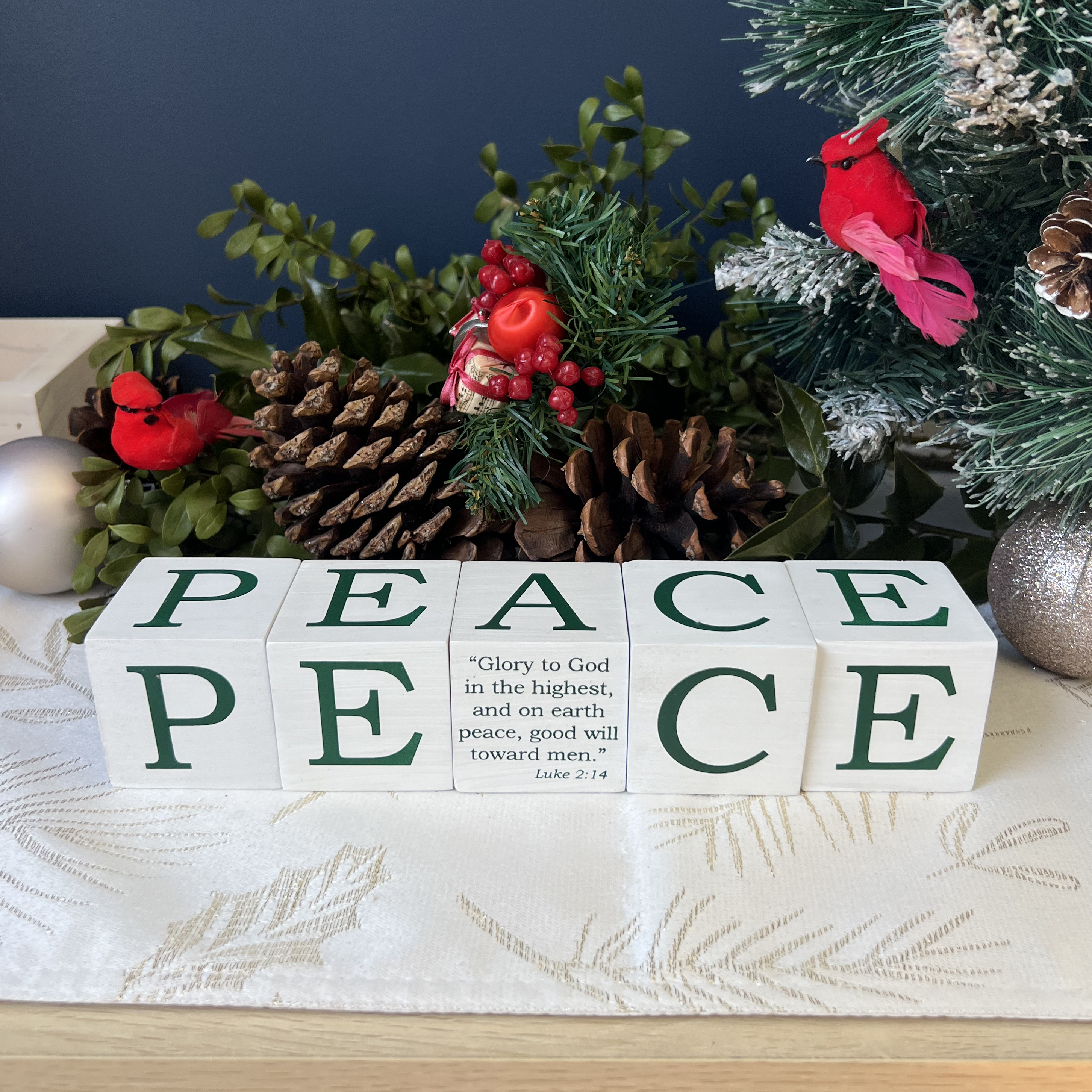 PEACE BLOCKS 5 PC SET. WHITEWASHED AND SCREEN PRINTED WOOD WITH THE SAME LETTER ON ALL SIDES. A IS REPLACED WITH SCRIPTURE ON ONE SIDE. EACH CUBE IS 2IN 