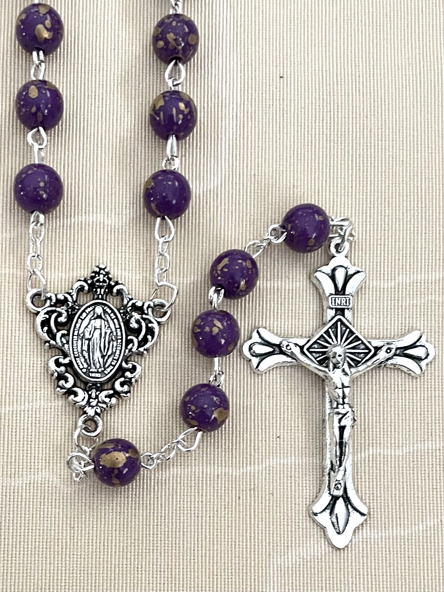 8MM AMETHYST SPECKLED ROSARY WITH SILVER OXIDIZED CRUCIFIX AND CENTERPIECE.