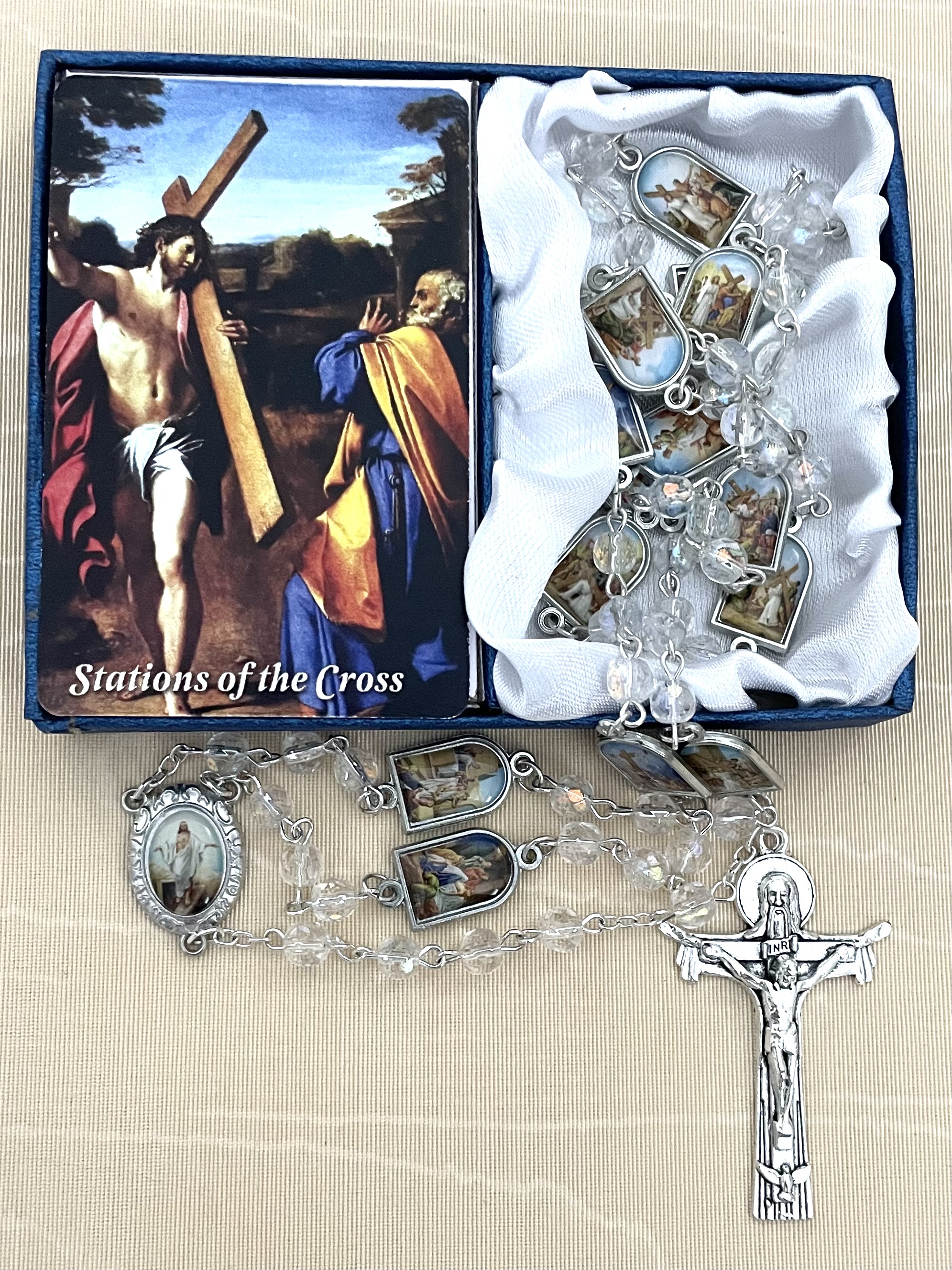 6MM CRYSTAL AB STATIONS OF THE CROSS ROSARY FEATURING ENAMEL METAL MEDALS DEPICTING THE STATIONS AS THE OUR FATHER BEADS. GIFT BOXED WITH PRAYER CARD.