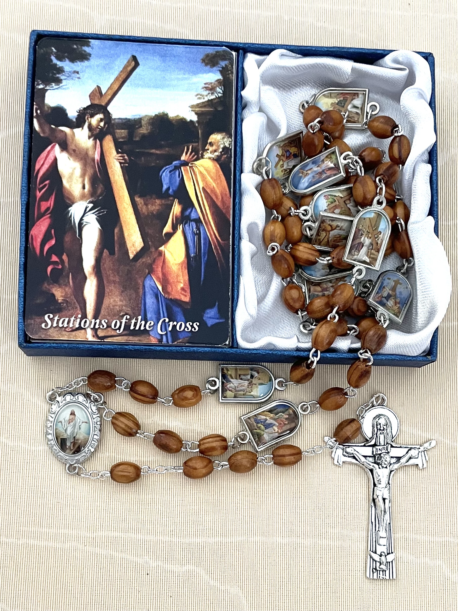 8X6MM BROWN WOOD STATIONS OF THE CROSS ROSARY FEATURING ENAMEL METAL MEDALS DEPICTING THE STATIONS AS THE OUR FATHER BEADS. GIFT BOXED WITH PRAYER CARD.