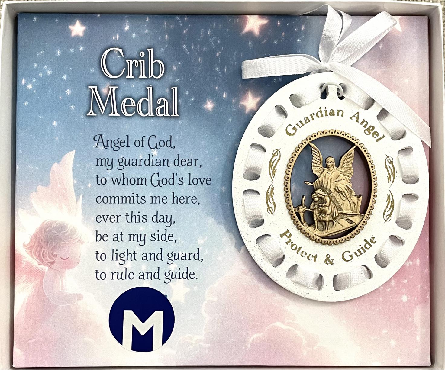 Crib Medal with White Ribbon woven through White Sparkled Wood with cut out oval with antique gold finish cast metal sculpted angel 3.5 in H x 3in W. Window box Crib Medal with White Ribbon woven through White Sparkled Wood with cut out oval with antique gold finish cast metal sculpted angel 3.5 in H x 3in W. Window box