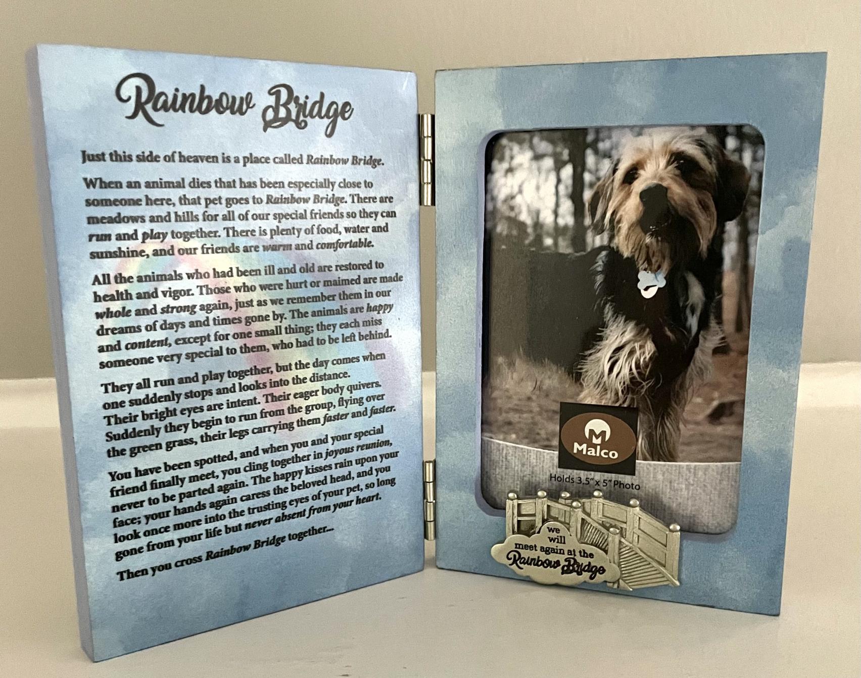 RAINBOW BRIDGE HINGED FRAME. WOOD FRAME ADORNED WITH METAL BRIDGE IN SILVER ENAMEL FINISH. COMES WITH 1 X 1.75 IN ENGRAVING PLATE FOR PERSONALIZATION. HOLDS 3.5 X 5 IN PHOTO. 8 X 6 IN. BOXED  