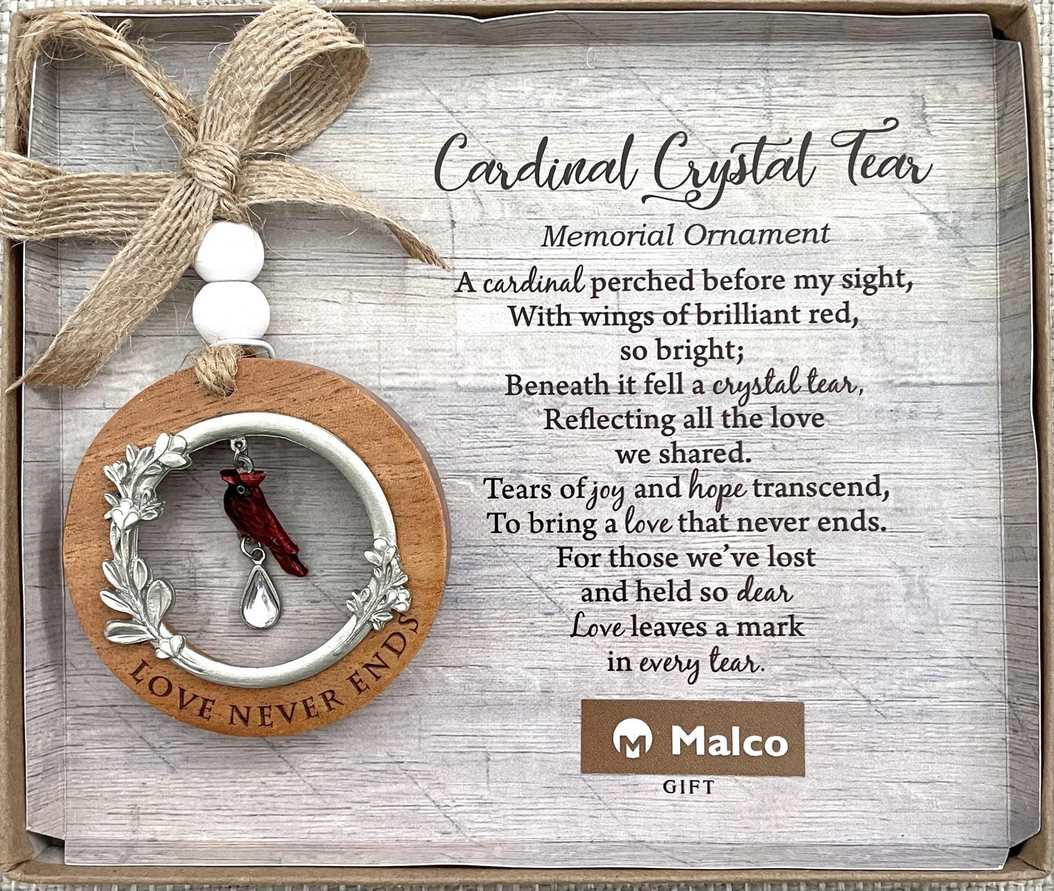 CARDINAL CRYSTAL TEAR MEMORIAL ORNAMENT. Lase engraved cedar with cast metal bezel finished in silver enamel with epoxy filled flowers, cast metal cardinal with translucent epoxy and crystal teardrop, jute ribbon and wooden beads CARDINAL CRYSTAL TEAR MEMORIAL ORNAMENT. Lase engraved cedar with cast metal bezel finished in silver enamel with epoxy filled flowers, cast metal cardinal with translucent epoxy and crystal teardrop, jute ribbon and wooden beads