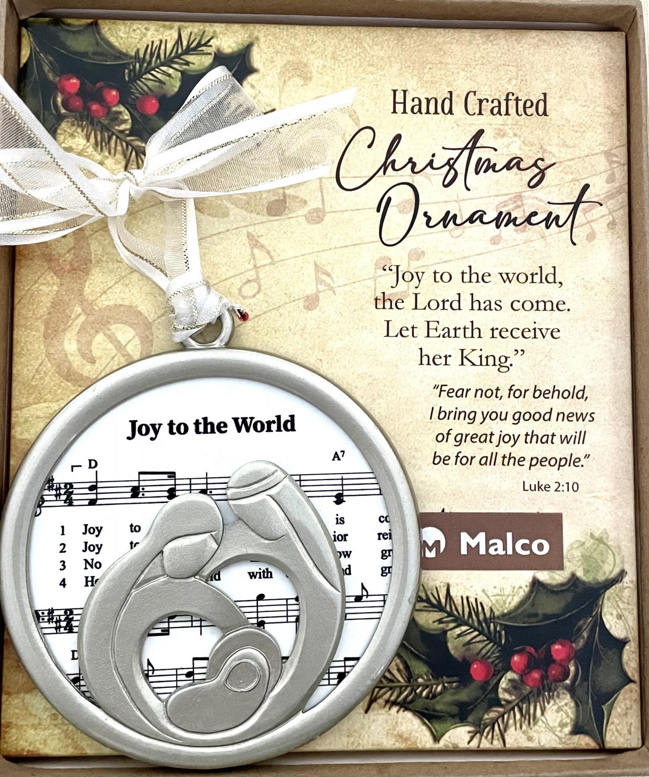 JOY TO THE WORLD CHRISTMAS CAROL ORNAMENT. CAST METAL, FINISHED IN SILVER ENAMEL, FRAME SUBLIMATED WOOD WHICH FEATURES SHEET MUSIC. HANGS FROM WHITE ORGANZA RIBBON. ORNAMENT SITS ON A DECORATIVE PAD, HIGHLIGHTING A SEFMENT OF THE CAROL WITH CORRESPONDING SCRIPTURE. 3.5 IN DIAMETER. WINDOW BOXED