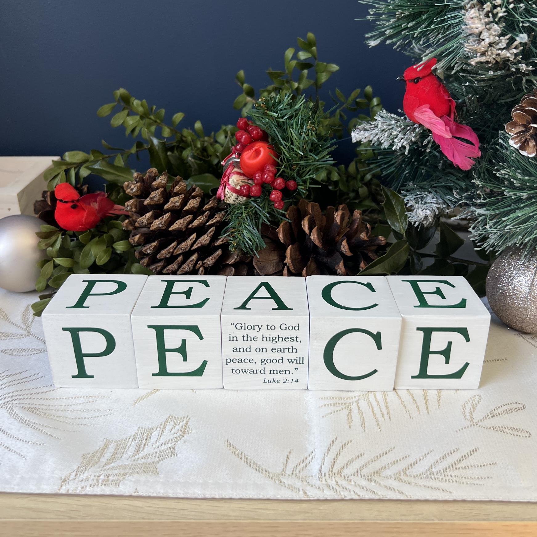 PEACE BLOCKS 5 PC SET. WHITEWASHED AND SCREEN PRINTED WOOD WITH THE SAME LETTER ON ALL SIDES. A IS REPLACED WITH SCRIPTURE ON ONE SIDE. EACH CUBE IS 2IN 