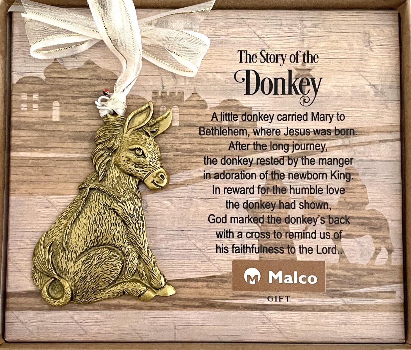 DONKEY ORNAMENT. CAST METAL ANTIQUE GOLD ENAMEL FINISH. HANGS ON WHITE ORGANZA RIBBON. 2.5IN W X 3.5IN H. WINDOW BOXED