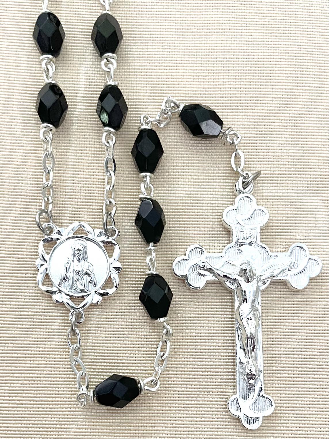 6X8MM BLACK FACETTED TIN CUT LOC LINK ROSARY WITH STERLING SILVER PLATE CRUCIFIX AND CENTER. GIFT BOXED