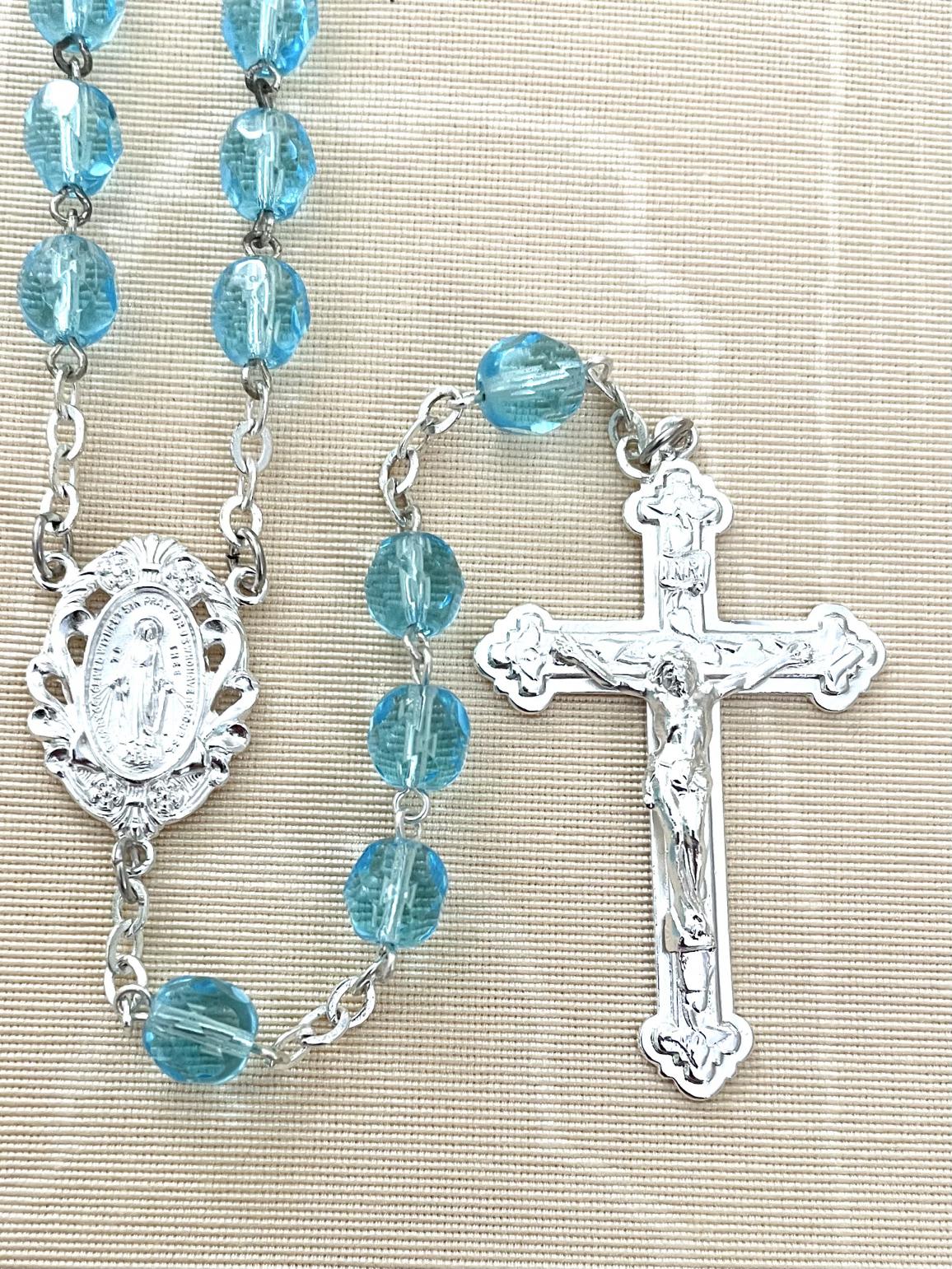 7MM AQUA DIAMOND CUT ROSARY WITH STERLING SILVER PLATE CRUCIFIX AND CENTER. GIFT BOXED