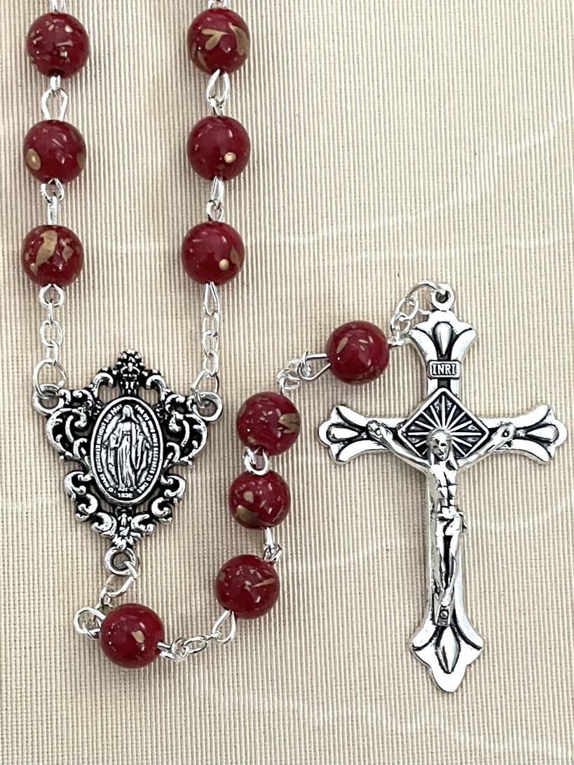 8MM RUBY SPECKLED ROSARY WITH SILVER OXIDIZED CRUCIFIX AND CENTERPIECE.