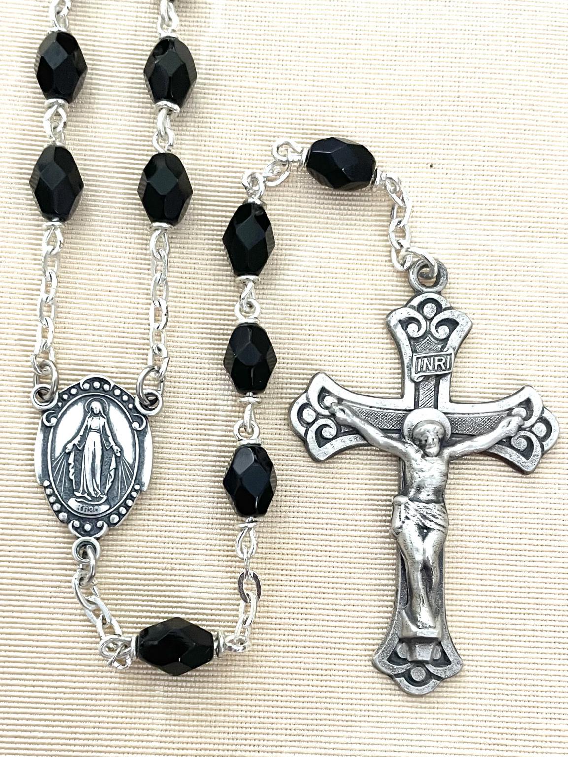 6X8MM BLACK FACETTED TIN CUT LOC LINK ROSARY WITH STERLING SILVER CRUCIFIX AND CENTER. GIFT BOXED