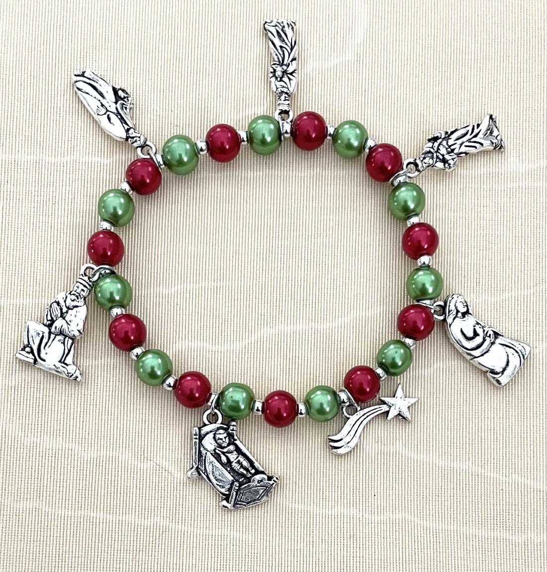 CHRISTMAS BRACELET WITH RUBY AND EMERALD PEARL BEADS. SILVER OXIDIZED METAL NATIVITY CHARMS ADORN THIS FESTIVE BRACELET