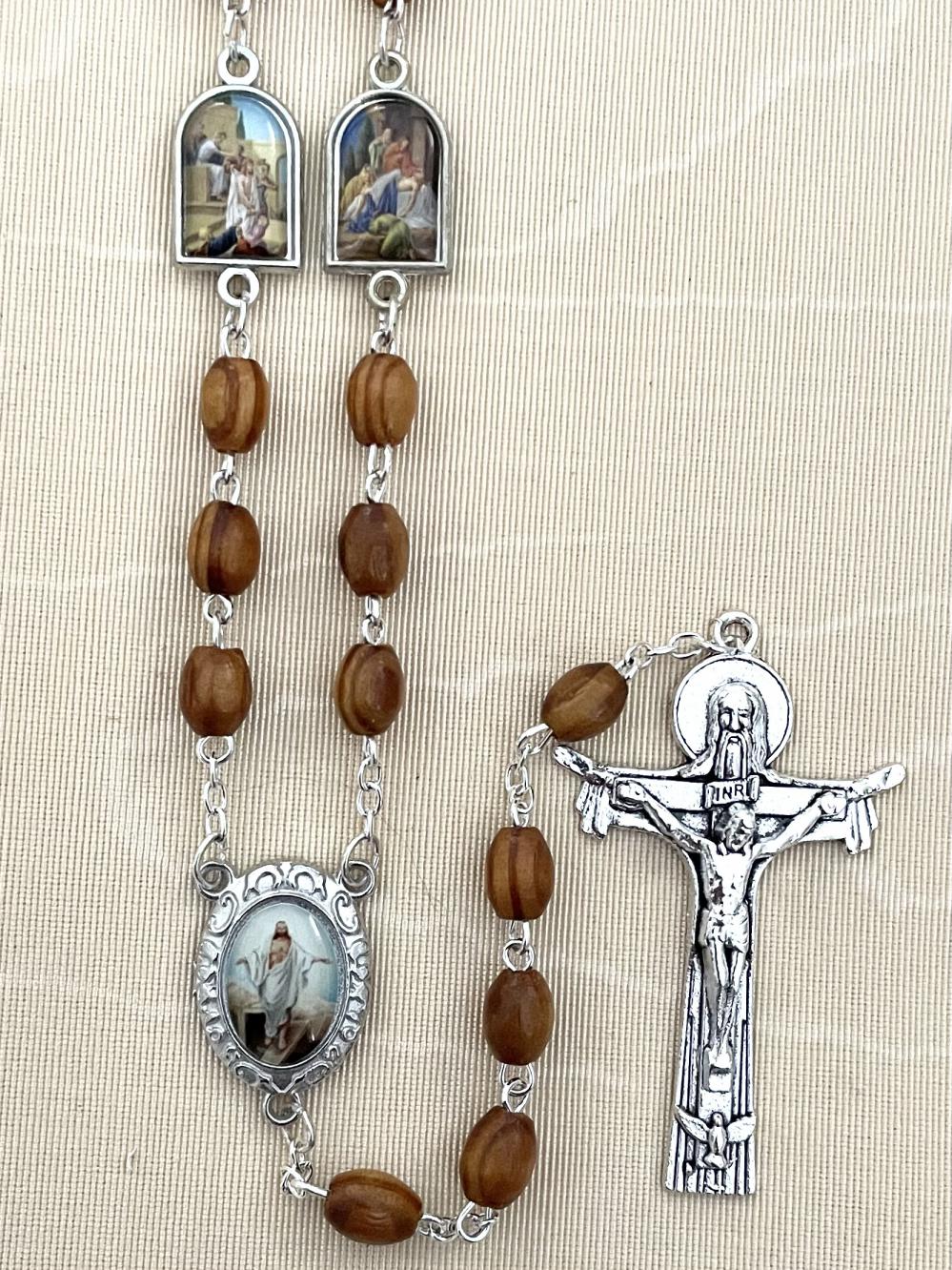 8X6MM BROWN WOOD STATIONS OF THE CROSS ROSARY FEATURING ENAMEL METAL MEDALS DEPICTING THE STATIONS AS THE OUR FATHER BEADS. GIFT BOXED WITH PRAYER CARD.